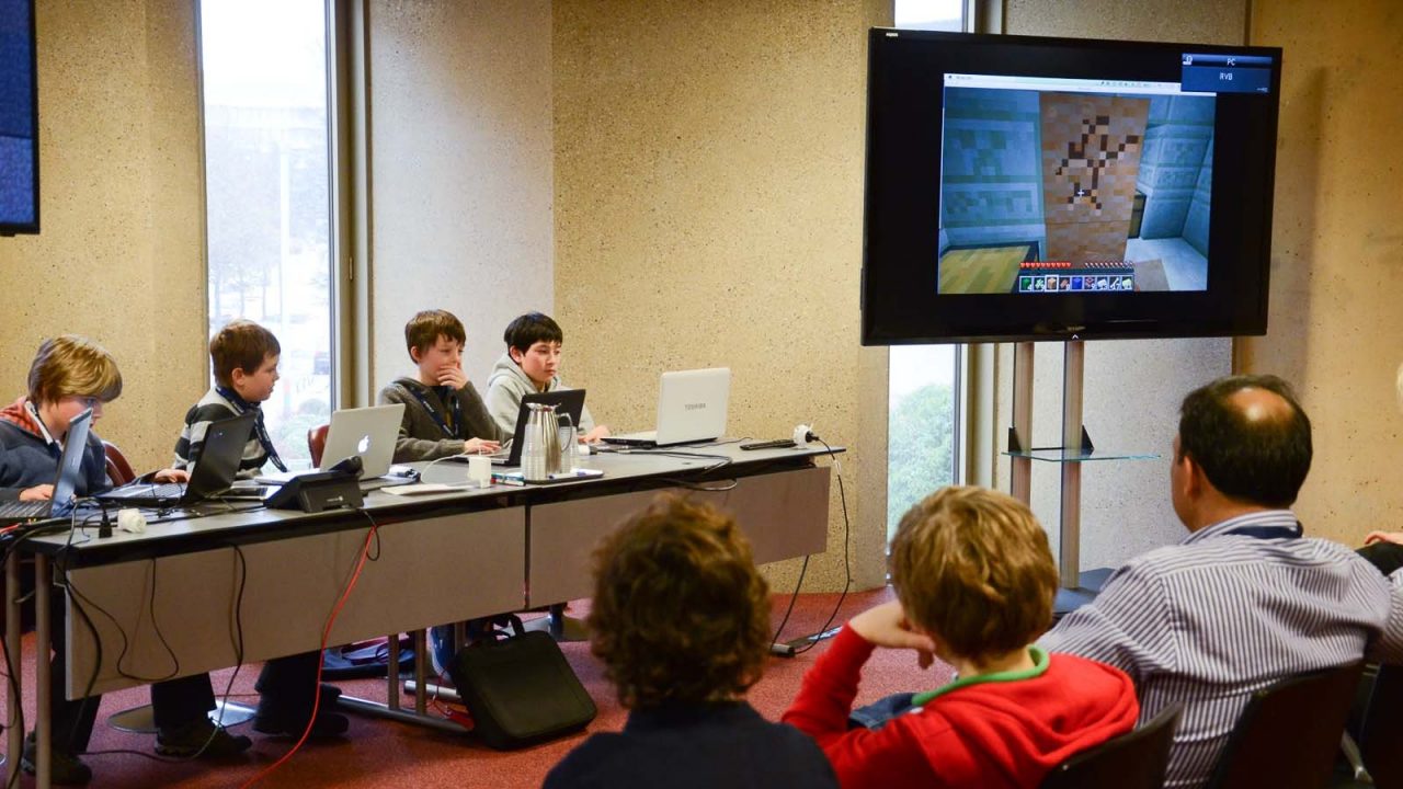 Children playing Minecraft on laptops during a Minecraft masterclass workshop